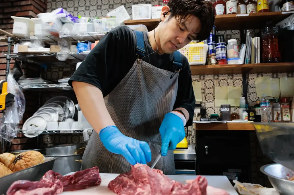 働く仲間（サービススタッフinaさん）　キッチンで仕込み作業を行う姿